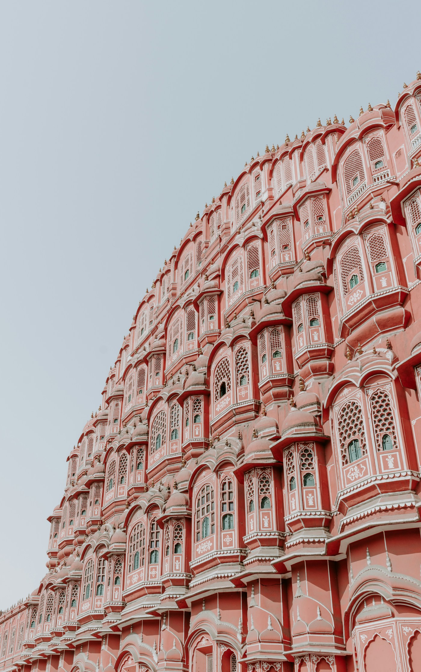 The ornate pink sandstone facade of Hawa Mahal in Jaipur
